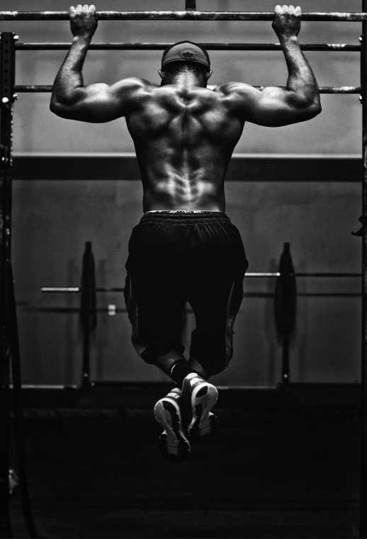man pulling up on a bar
